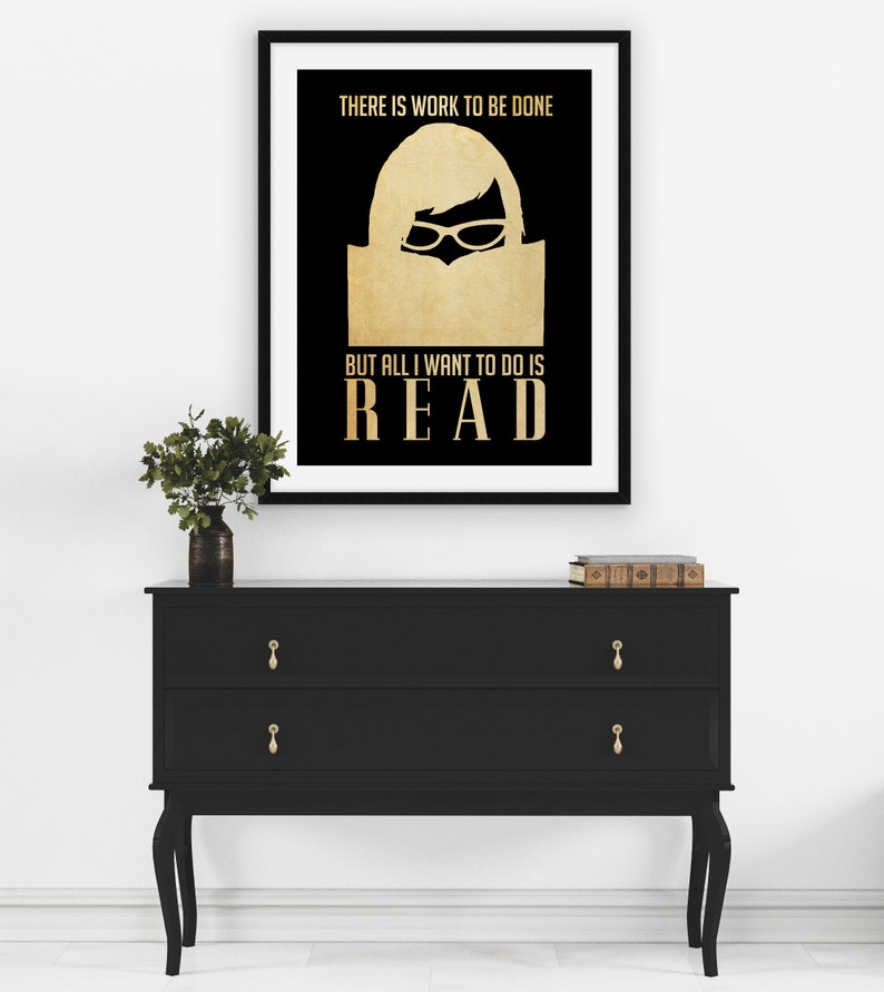 May include: A black and gold poster with the text "THERE IS WORK TO BE DONE BUT ALL I WANT TO DO IS READ". The poster features a silhouette of a person reading a book.