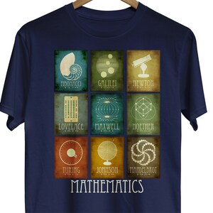 May include: A navy blue t-shirt with a graphic of nine squares featuring different mathematical symbols and the names of mathematicians. Each square has a different color background and the text "MATHEMATICS" is printed below the squares.