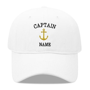 May include: White baseball cap with black embroidery that reads "CAPTAIN" and "NAME" with a gold anchor in between the words.