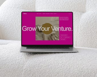 May include: A silver laptop displaying a website with a vibrant magenta background and the text "Mons" and "Grow Your Venture." The screen features a central square image, a gold circle overlay, and navigation links for home, about, services, and contact.