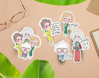 May include: A collection of colorful stickers featuring cartoon illustrations of characters with text. The stickers depict women in various outfits, with phrases like "Picture it Sicily" and "Shady Pines Ma!" on them. The stickers are on a tan surface.
