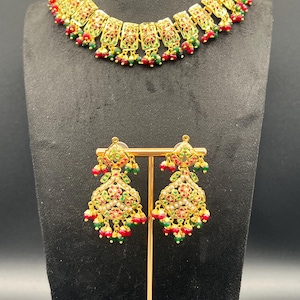 Hyderabadi jadau necklace set in red and green color.