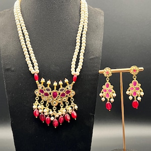 Hyderabadi jadau big pendant set. 22 carat gold plated with earrings and double pearl strings