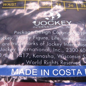 May include: A dark blue plastic packaging material featuring the Jockey International, Inc. logo and text. The text includes Package Design Copyright 1996, trademark information, a Kenosha, Wisconsin address, and the text MADE IN COSTA RICA.