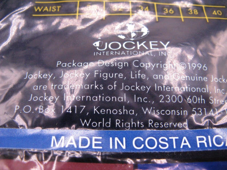 May include: A dark blue plastic packaging material featuring the Jockey International, Inc. logo and text. The text includes Package Design Copyright 1996, trademark information, a Kenosha, Wisconsin address, and the text MADE IN COSTA RICA.