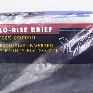 May include: A package of dark-colored lo-rise briefs made of 100% cotton. The packaging features a maroon and dark blue label with white text that reads LO-RISE BRIEF, 100% COTTON, and EXCLUSIVE INVERTED Y-FRONT FLY DESIGN, along with a graphic.