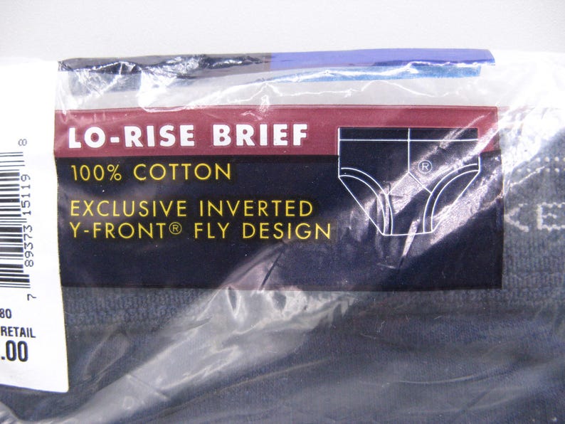 May include: A package of dark-colored lo-rise briefs made of 100% cotton. The packaging features a maroon and dark blue label with white text that reads LO-RISE BRIEF, 100% COTTON, and EXCLUSIVE INVERTED Y-FRONT FLY DESIGN, along with a graphic.