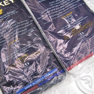 May include: Two packages of Jockey Life briefs in dark blue plastic wrapping. The packaging features white text detailing 100% combed cotton, a low waistline, high-on-the-thigh leg openings, a two-layer pouch, and an exclusive Inverted Y-Front fly.