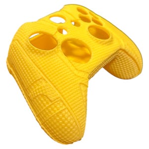 May include: Bright yellow silicone controller cover with a textured, dotted pattern. The cover has openings for buttons and joysticks, designed to fit a gaming controller. The cover is made of a flexible material.
