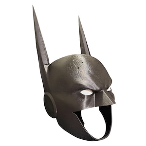May include: A black, full-head mask featuring two tall, pointed ears extending upward from the top. The mask has a smooth, dark finish with white mesh eye coverings and a wide, open mouth area, designed to cover the head and face completely.