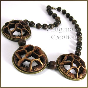 A finished necklace with openwork and carved polymer clay focal beads to demonstrate the use of Eugena's openwork technique.  Painting and assembling the openwork elements is out of the scope for this tutorial.