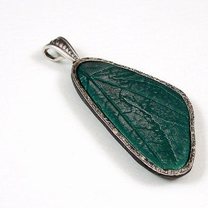 A picture of a polymer clay pendant with a DIY sterling silver bezel (frame).