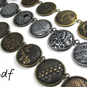 Polymer Clay Tutorial Textures and Metal Look Imitation, front page with three necklaces in different colors.  These necklaces demonstrate various textures that can be created by hand, with commercial stamps, or with found objects.