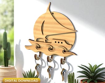 May include: Wooden sailboat key holder with three key hooks. The key holder is light brown and features a sailboat design with waves. The keys are silver. The words "DIGITAL DOWNLOAD" and file type information are in the bottom left corner.
