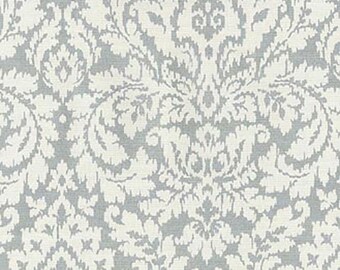 May include: A white fabric with a gray damask pattern. The pattern is a repeating design of stylized leaves and swirls.