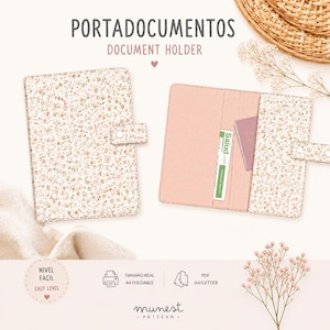 May include: A document holder with a floral pattern in shades of beige and brown. The holder features a snap closure and an interior pocket containing a card labeled Salud. The text Portadocumentos Document Holder is visible at the top.