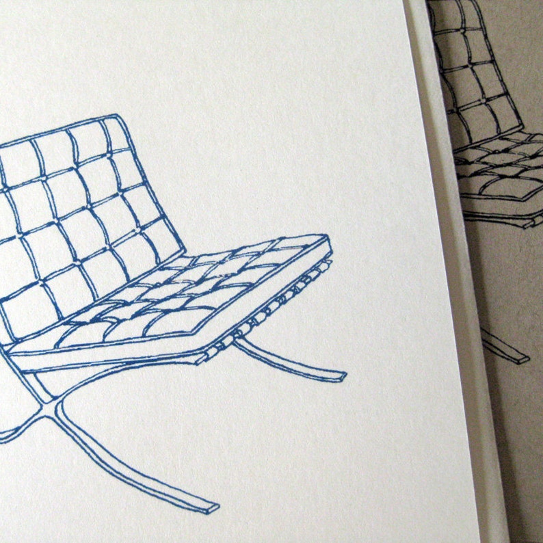 May include: A blue line drawing of a modern chair with a grid-patterned seat and a curved, metal frame. The chair is set against a white background, with a partial view of a similar chair in the background.
