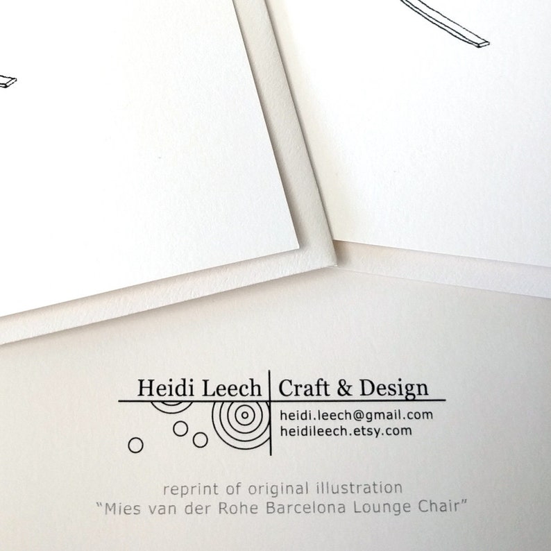 May include: Two white art prints with minimalist line drawings of furniture. The prints are layered, with the top one partially obscuring the other. The bottom of the image includes the text "Heidi Leech Craft & Design" and "Mies van der Rohe Barcelona Lounge Chair."