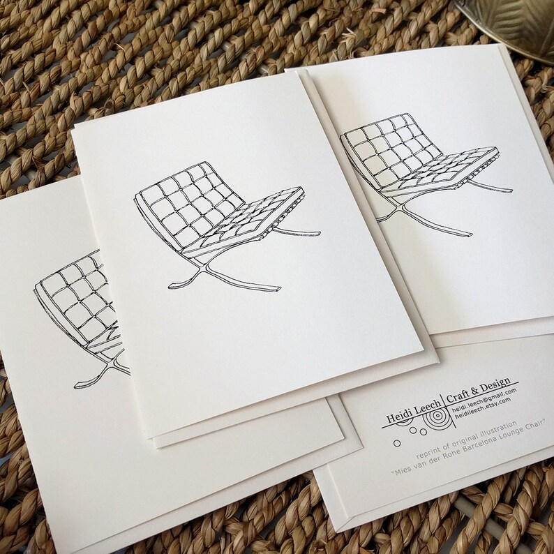 May include: Several white cards with a black line drawing of the Mies van der Rohe Barcelona lounge chair. The cards are on a woven surface. The text "Heidi Leech Craft & Design" and contact details are visible.