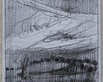 May include: A square ceramic tile featuring a graphite pencil drawing of a landscape. The artwork depicts a field with dark, vertical hatching lines, a cluster of trees, and a sky filled with swirling, layered cloud formations.