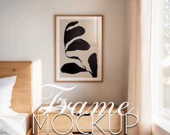 May include: A wooden nightstand with two drawers and a framed black and white abstract print of a leaf hanging on a white wall above it.