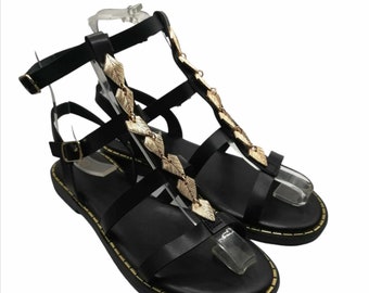 Black ancient Greek sandals with gold metal decoration and many straps