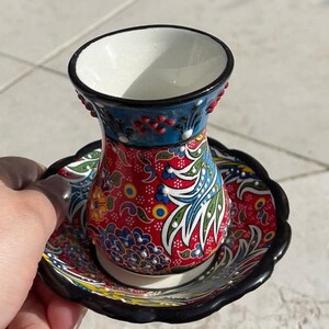 A cup for tea, or it could be for coffee. It is an Arabic-Turkish type, made of ceramic. Its color is yellow, green, blue, red, and white.