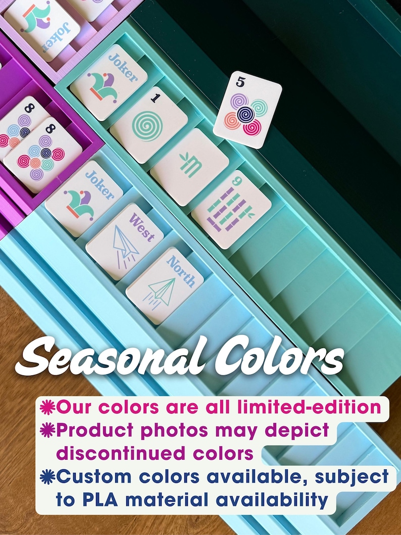 May include: A multi-colored plastic game card organizer tray with various compartments containing playing cards featuring Joker, number, and directional symbols. The text Seasonal Colors and a disclaimer about limited-edition colors are visible.