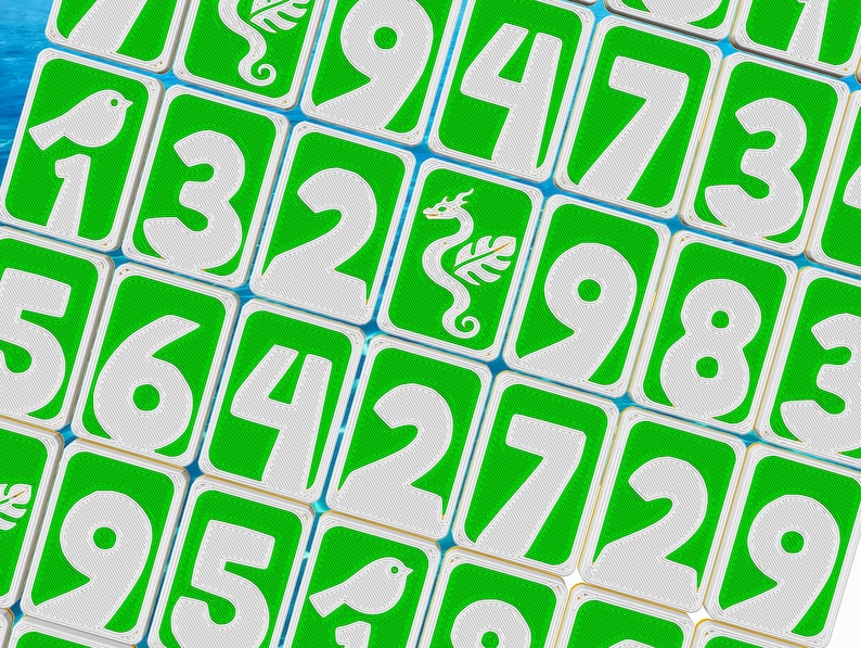 May include: Close-up of a collection of green and white number tiles. Each tile features a large white number against a green background. Some tiles have small white illustrations of a bird or a seahorse. The tiles are arranged in a grid pattern.