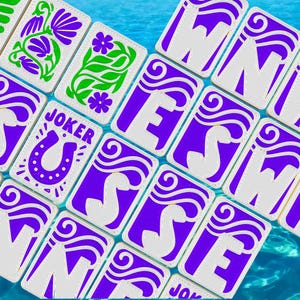 May include: A collection of playing cards with a white background and purple and green designs. Some cards feature the word "JOKER" and a horseshoe. Other cards display the letters "W", "E", and "S".