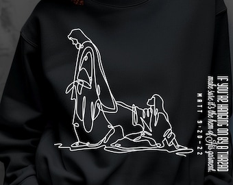 May include: Black sweatshirt featuring a white line drawing of two figures. The text "IF YOU'RE HANGING ON BY A THREAD make sure it's the hem of His garment. MATT 9 20-22" is printed vertically on the right sleeve. The words "ONLY DIGITAL DOWNLOAD" are printed on the left side.