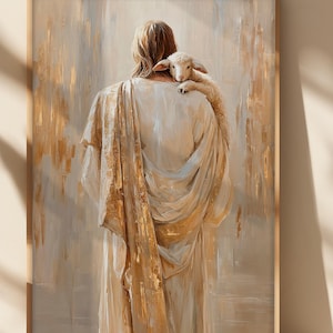 May include: A framed art print showing a figure in flowing robes, with a lamb on their shoulder. The artwork uses a warm palette of gold, beige, and white, with visible brushstrokes. The image creates a feeling of peace and compassion.