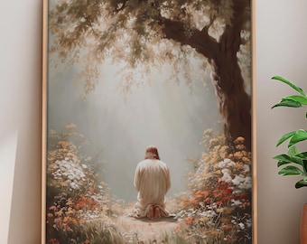 May include: A framed art print depicting a person kneeling in prayer beneath a large tree. The artwork features soft, muted colors, with a focus on the figure's back and the surrounding foliage. The scene evokes a sense of peace and contemplation.
