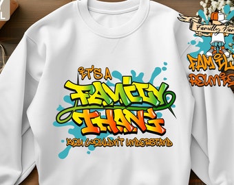 May include: White sweatshirt with a graphic design that says "It's a Family Thang You Wouldn't Understand" in a graffiti style with yellow, green, and blue colors.