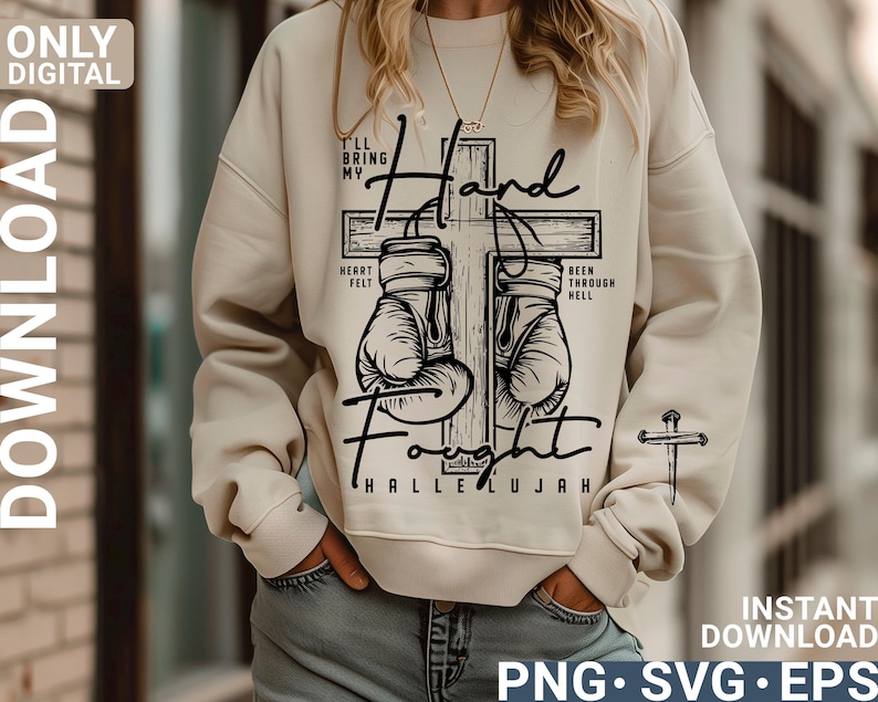 May include: Cream-colored sweatshirt with a graphic design featuring boxing gloves on a cross, with the words "I'll bring my heart felt fought hallelujah" and "been through hell". A small cross is on the sleeve.