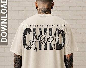 May include: A beige short-sleeve t-shirt featuring black distressed lettering on the back. The text reads 2 CORINTHIANS 6:18 above the word CHILD in a large, weathered font, with the words of GOD written in a script font across the center.