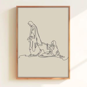 May include: A framed art print with a minimalist line drawing of two figures. The black artwork shows one figure standing and another kneeling, set against a beige background. The frame is a warm, natural wood tone.