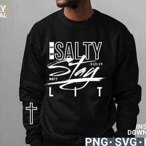 May include: Black sweatshirt with the words "BE SALTY STAY LIT" in white script. The text includes the Bible verse Matthew 5:13-14 and a cross graphic. The words "ONLY DIGITAL DOWNLOAD" are on the left side.