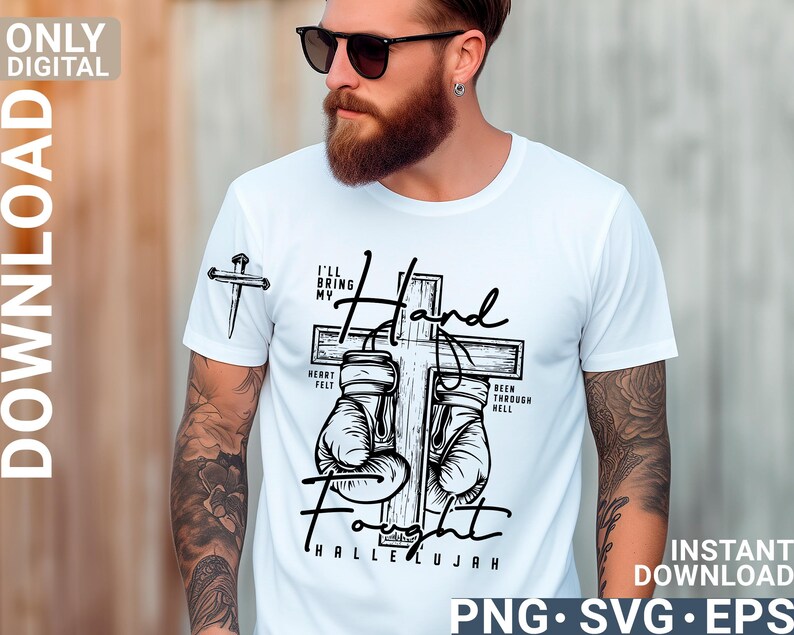 May include: White t-shirt with a graphic design featuring a cross, boxing gloves, and the words "I'll Bring My Hand Fight Hallelujah." The shirt also has a small cross graphic on the sleeve.
