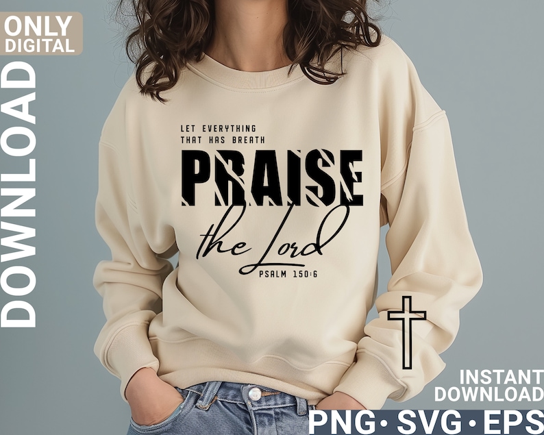 May include: A beige sweatshirt with black text that reads "Let everything that has breath praise the Lord Psalm 150:6". The word "praise" is in a bold, striped font. A white outline of a cross is on the right sleeve of the sweatshirt.