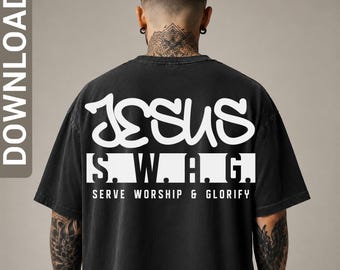 May include: A black short-sleeved t-shirt featuring white graphic text on the back. The design includes the words JESUS in a stylized font, followed by S.W.A.G. inside a white rectangular block, and the text SERVE WORSHIP & GLORIFY below it.