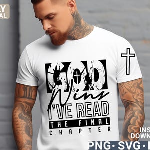 May include: A white t-shirt with a black graphic that says "God Wins I've Read The Final Chapter" with a cross in the graphic. There is a black cross on the right sleeve of the shirt.