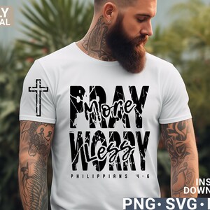 May include: A white t-shirt with black text that reads "Pray More Worry Less" with a cross above the text and "Philippians 4:6" below the text.