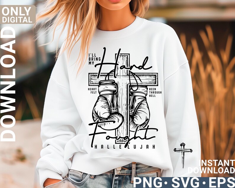 May include: White sweatshirt with a black graphic of a cross, boxing gloves, and the words "I'll bring my hand fought" and "Hallelujah." The design includes the phrases "Heart Felt" and "Been Through Hell."
