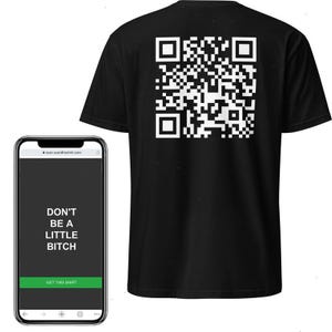May include: Black t-shirt with a large white QR code on the back. A smartphone displays the text "DON'T BE A LITTLE BITCH" with a "GET THIS SHIRT" button. The phone screen is black with white text.