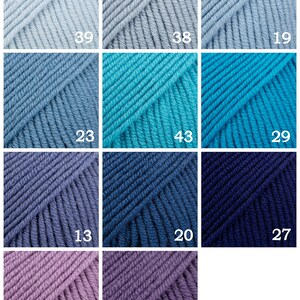 May include: A collection of 10 yarn skeins in various shades of blue, teal, purple, and gray. The skeins are arranged in a grid pattern with numbers 19, 38, 39, 29, 43, 23, 27, 20, 13, 44, and 22 printed on each skein.