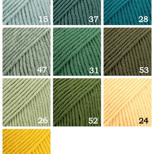 May include: A collection of yarn balls in various shades of green, blue, yellow, and beige. The yarn balls are arranged in a grid pattern with numbers indicating the color code.