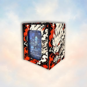 May include: A rectangular deck box for trading cards featuring a black, white, and red graphic illustration of a snarling wolf surrounded by swirling smoke and flames. A clear window on the front displays a single playing card inside the container.