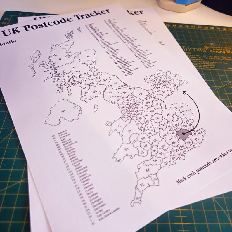 May include: A black and white map of the United Kingdom with the text "UK Postcode Tracker" and "Month:" at the top. The map is divided into regions with their corresponding postcode abbreviations. The map includes an arrow pointing to the London area with the text "Mark each postcode area when you" at the bottom.