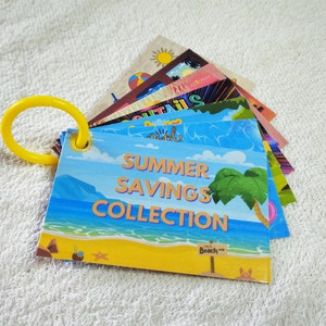 May include: A stack of colourful cards with a summer theme. The top card is blue and yellow with the text "Summer Savings Collection" and a palm tree. The cards are attached to a yellow ring.